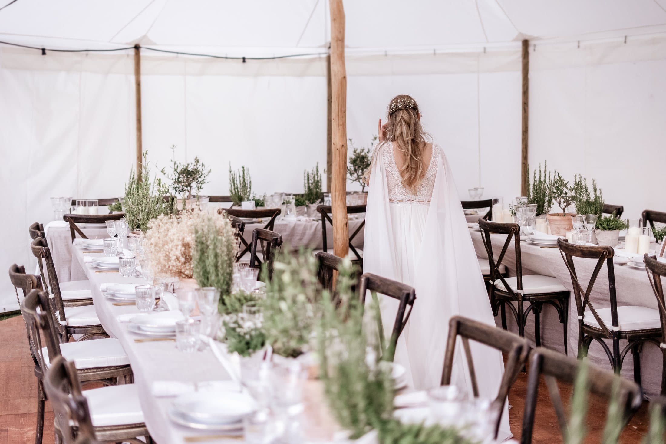 Bride at the long wedding table in the fabric tent on Lake Como