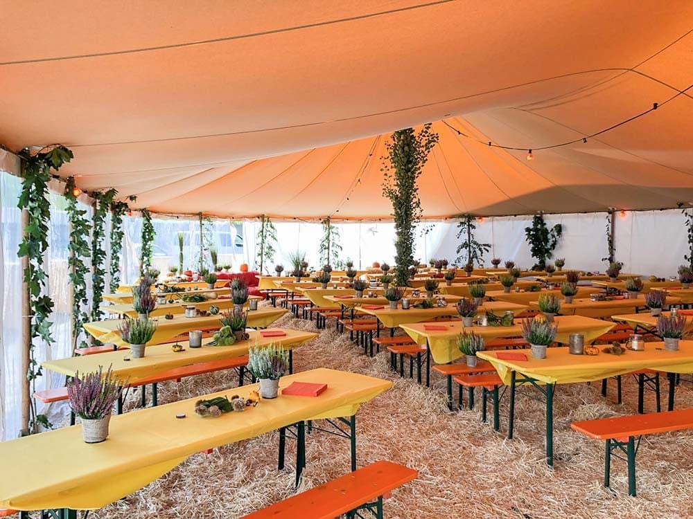 Tent with beer table sets at a harvest festival for 200 people