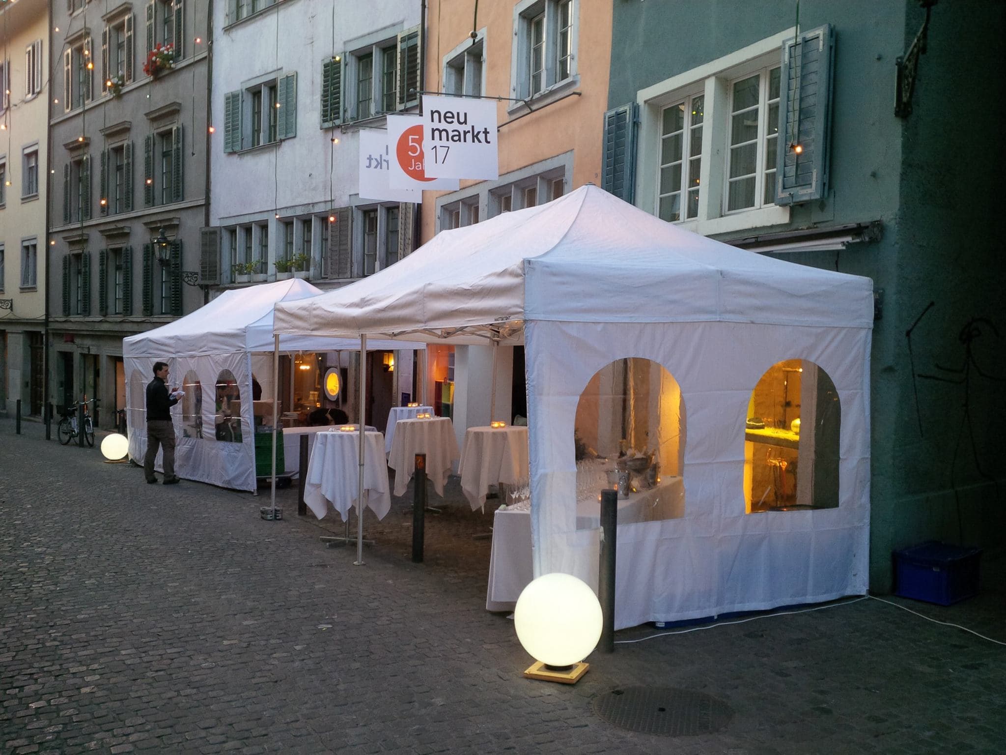 White pavilions in an old town lane in the evening